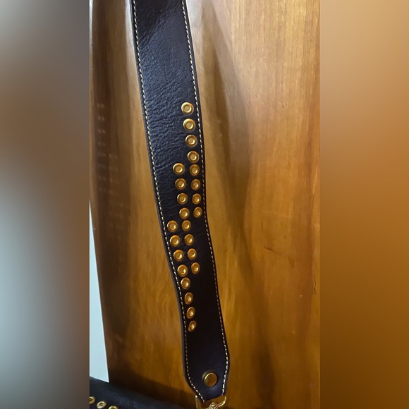 Black leather cross body purse with orange colored medallion on front. - Picture 12 of 14